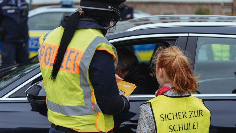 Blitz für Kids 2026: Eine Beamtin kontrolliert zusammen mit einer Schülerin einen Autofahrer.