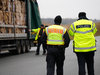 Polizisten kontrollieren Ladung eines Lkw.