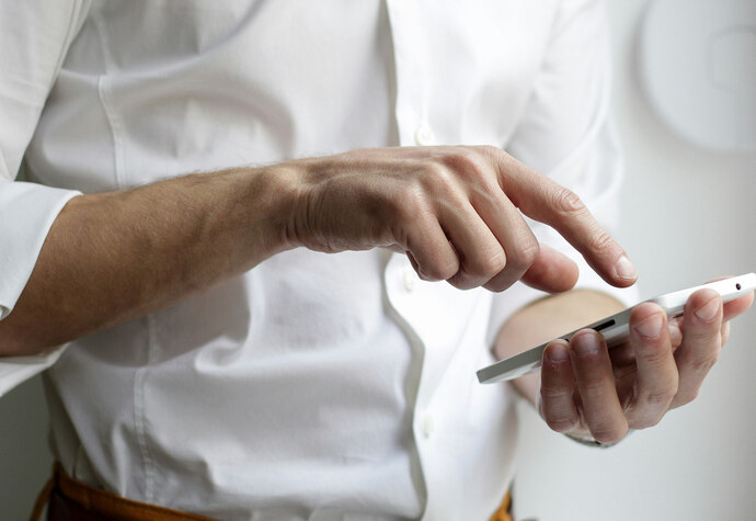 Mann tippt auf Smartphone
